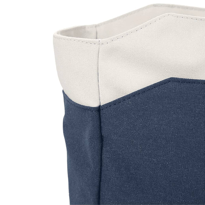 A close-up of a navy blue tote bag with a light grey top. The bag features contrasting fabric textures and a logo.
