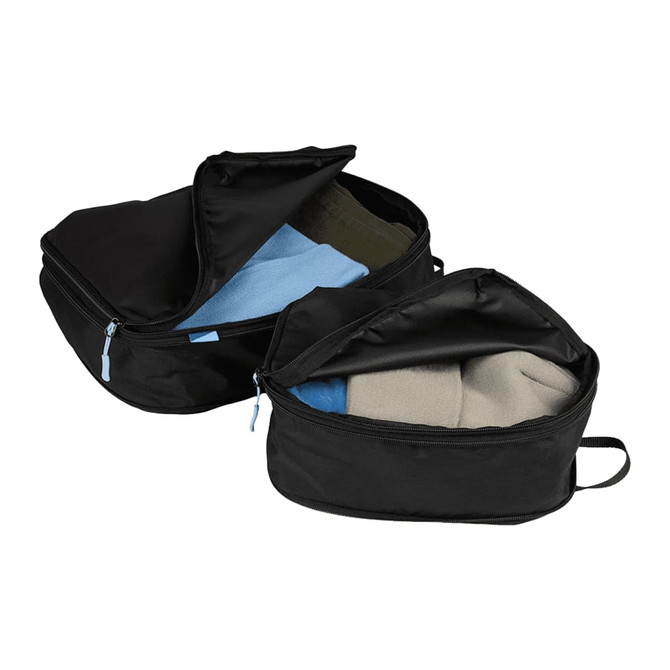 Two black compression packing cubes with open zippers revealing colourful items inside, set against a neutral background.