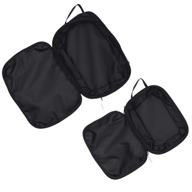 A set of three black compression packing cubes with zippers and handles for easy organisation.