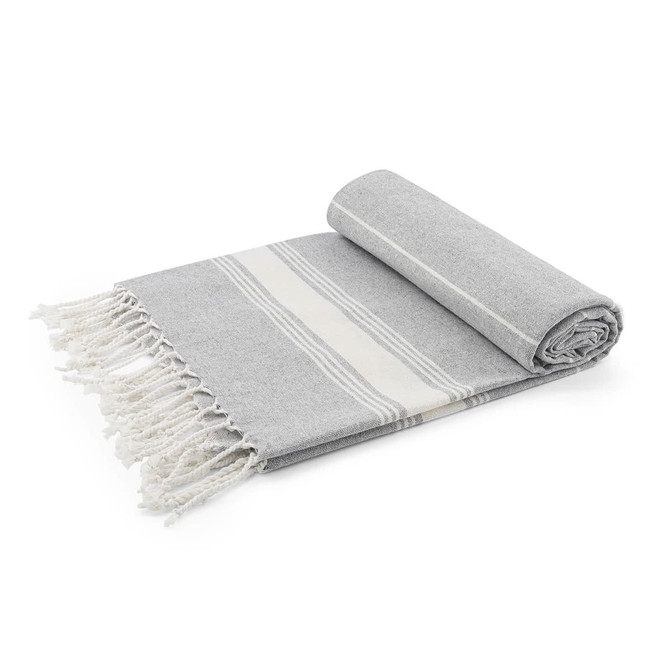 A rolled grey blanket with white stripes and fringed edges, featuring a soft, textured fabric.