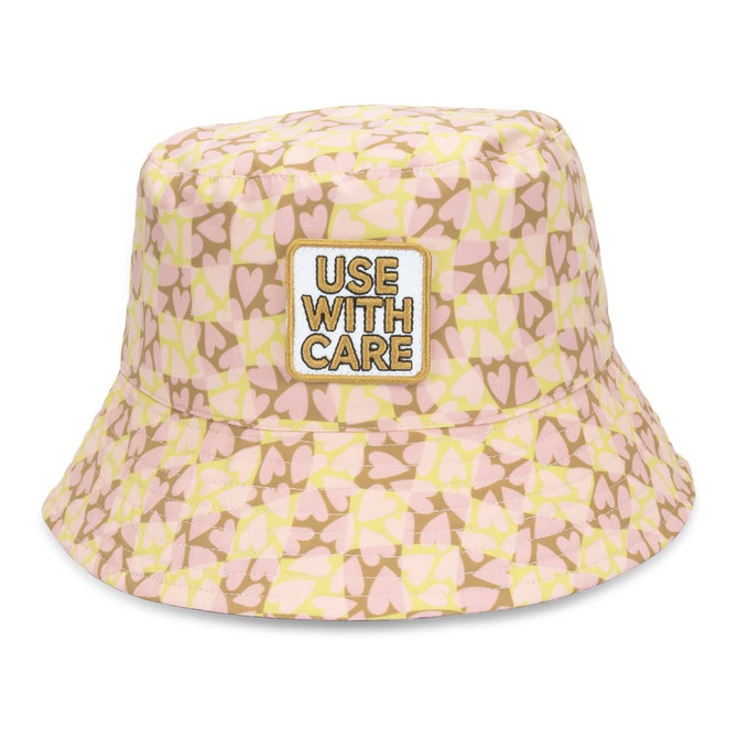 A pink and yellow patterned bucket hat featuring an embroidered patch. The design includes heart shapes and has a logo.