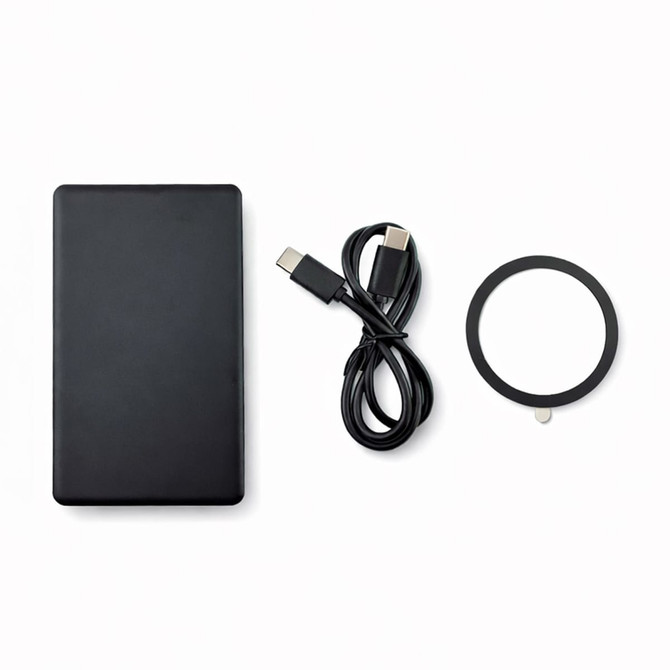 A black solid state power bank, a USB-C cable, and a circular accessory. The product features a logo.