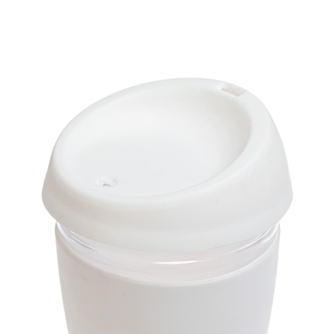 A reusable coffee cup featuring a clear body and a white silicone lid.