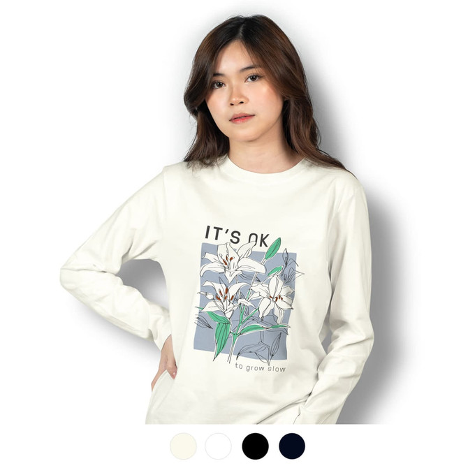 A long sleeve crew shirt in cream featuring floral graphics and a logo, displayed on a model.