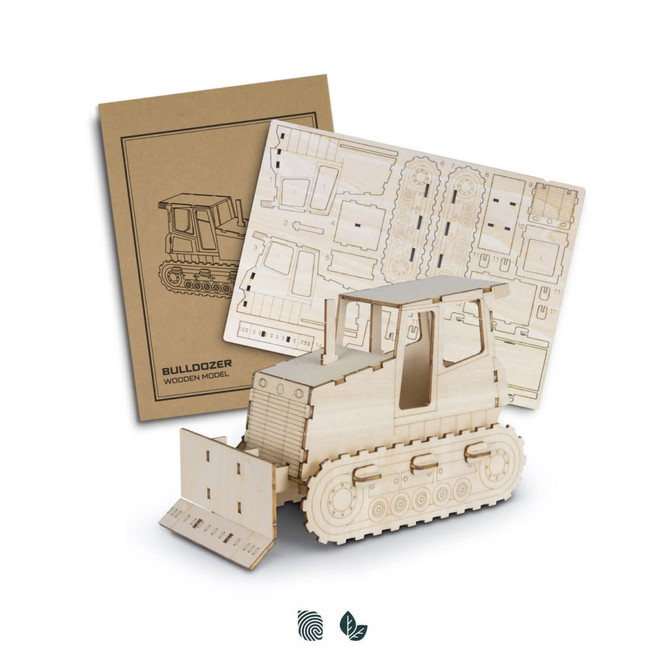 A wooden bulldozer model in natural wood finish with assembly sheets in the background, featuring a logo.