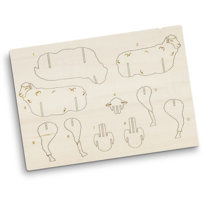 A wooden model kit featuring sheep-shaped pieces, intricate engravings, and numbered sections for assembly.