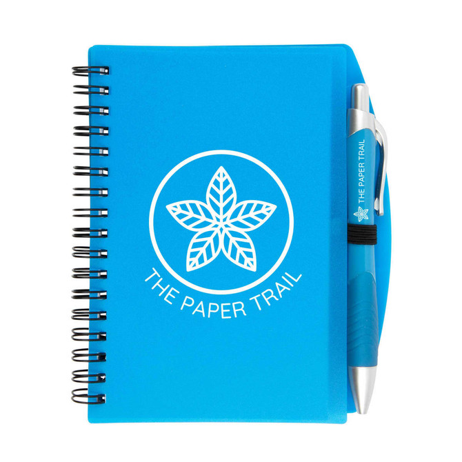 A blue spiral notebook with a pen attached, featuring a logo on the cover.