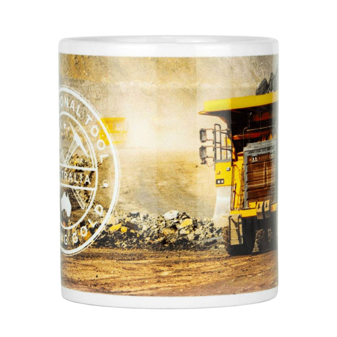 A ceramic coffee mug featuring a heavy machinery design, primarily in yellow and white, with a logo.