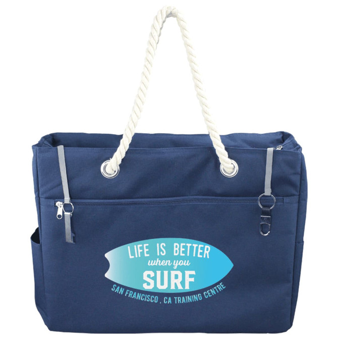 A navy blue waterproof beach bag with rope handles and a front pocket, featuring a logo on the side.