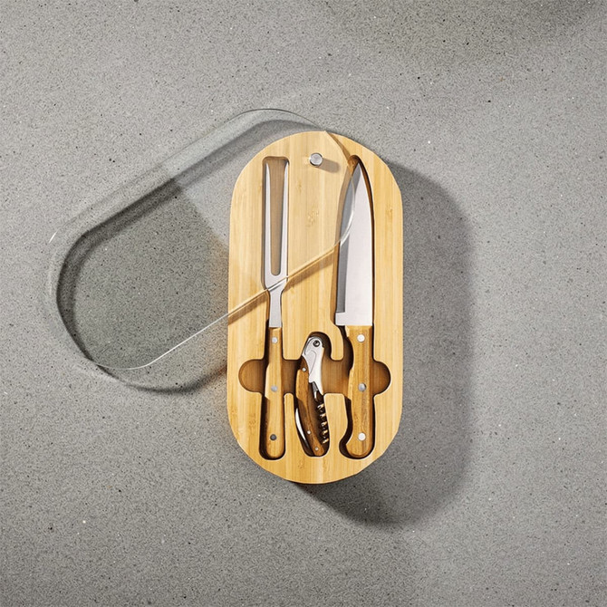 An oval bamboo knife set featuring a cheese knife, chef’s knife, and corkscrew, all with wooden handles.