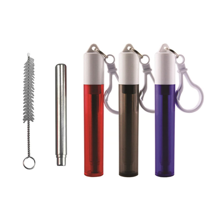 A set of four travel bottles in red, brown, and purple, with a cleaning brush and a keychain attachment.