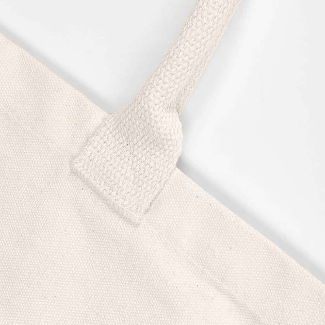 A close-up of a cream-coloured tote bag with textured handles and no gusset, featuring a logo.