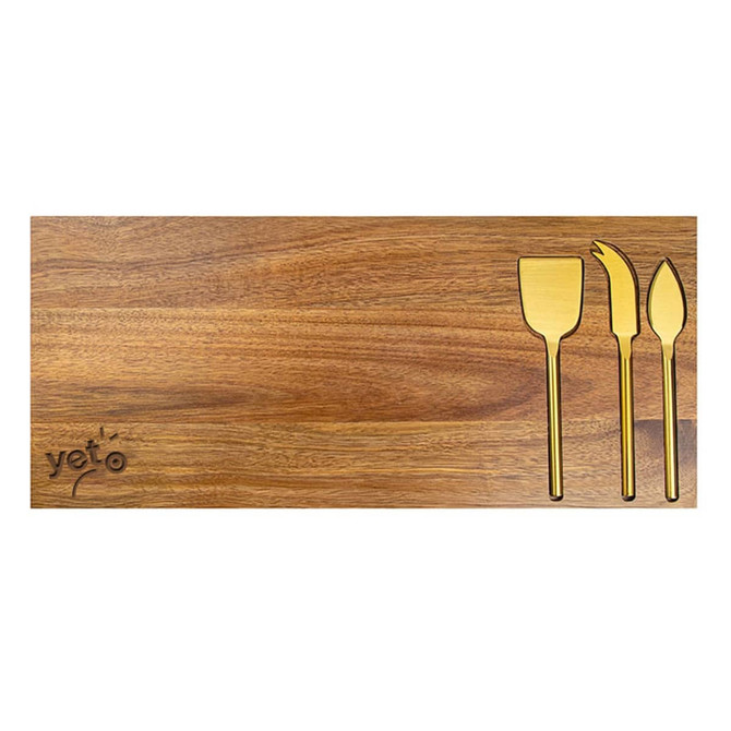 A wooden cheeseboard featuring three gold-coloured cheese knives and a logo.