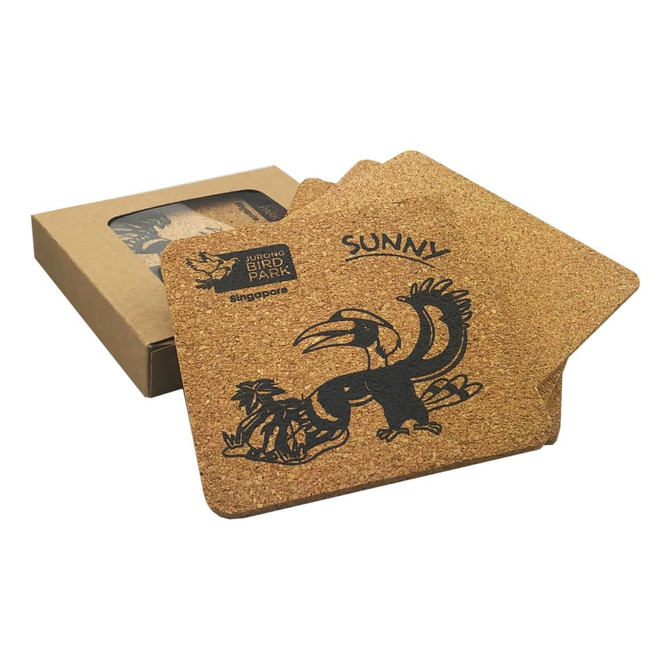 A square set of four cork coasters featuring a bird design, packaged in a brown box.