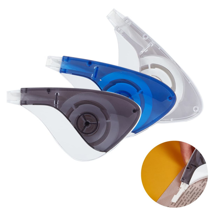 Three correction tape dispensers in grey, transparent, and blue, with a circular design and a logo on one.