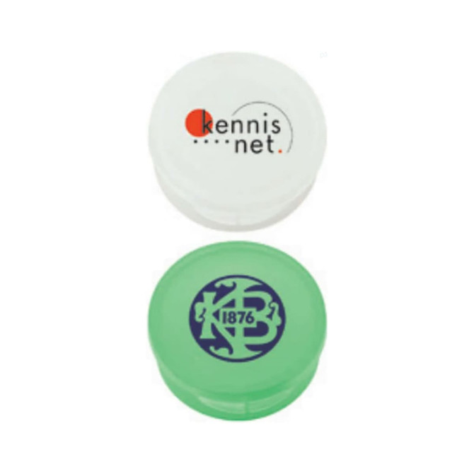 Two pill boxes, one white with a logo and one green featuring a different logo, both designed for personal use.