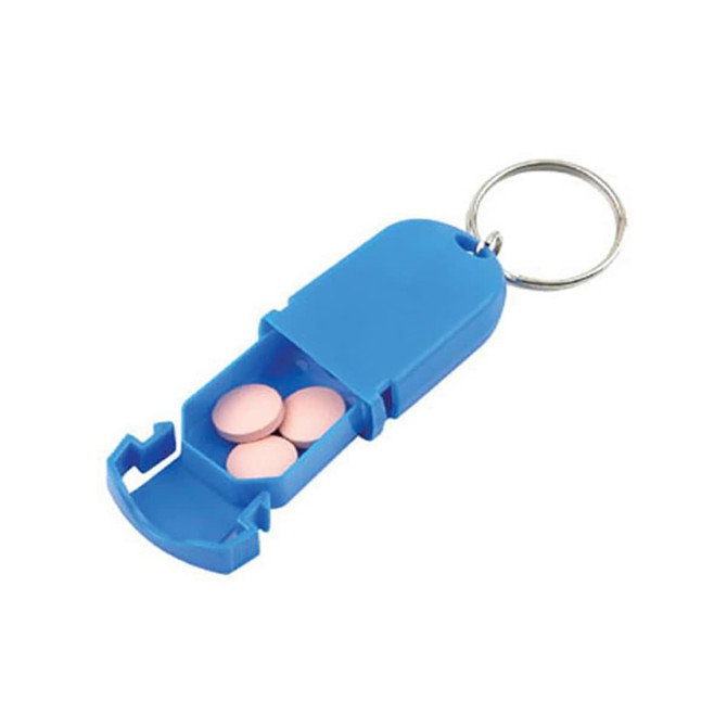 A blue pill box keychain containing pink tablets, featuring a secure flip-top design and a keyring attachment.