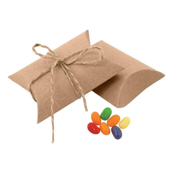 A pillow-shaped package tied with twine beside a mix of colourful jelly beans in green, orange, yellow, and purple.