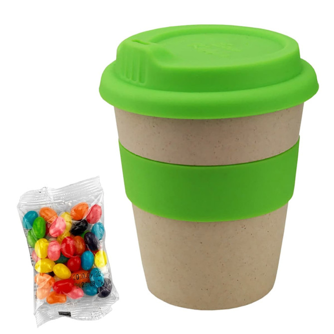 A bamboo cup with a bright green silicone lid and band, accompanied by a bag of colourful jelly beans.