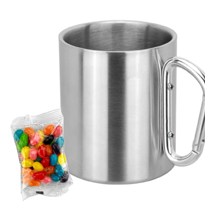 A stainless steel mug with a metal handle, accompanied by a pack of colourful jelly beans.