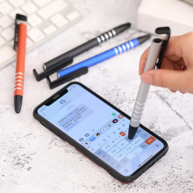 A silver stylus pen is held above a smartphone screen, surrounded by black, blue, and orange stylus pens.