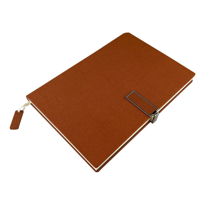A brown notebook with a textured cover, featuring a metal clip and bookmark. It has branding on the front.