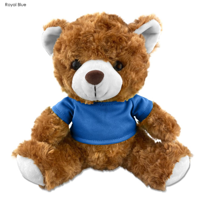 A brown plush teddy bear with a blue shirt, featuring white accents on its ears and a friendly expression.