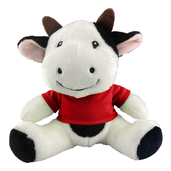 A plush cow toy with black and white fur, wearing a red shirt and featuring a smiling face.