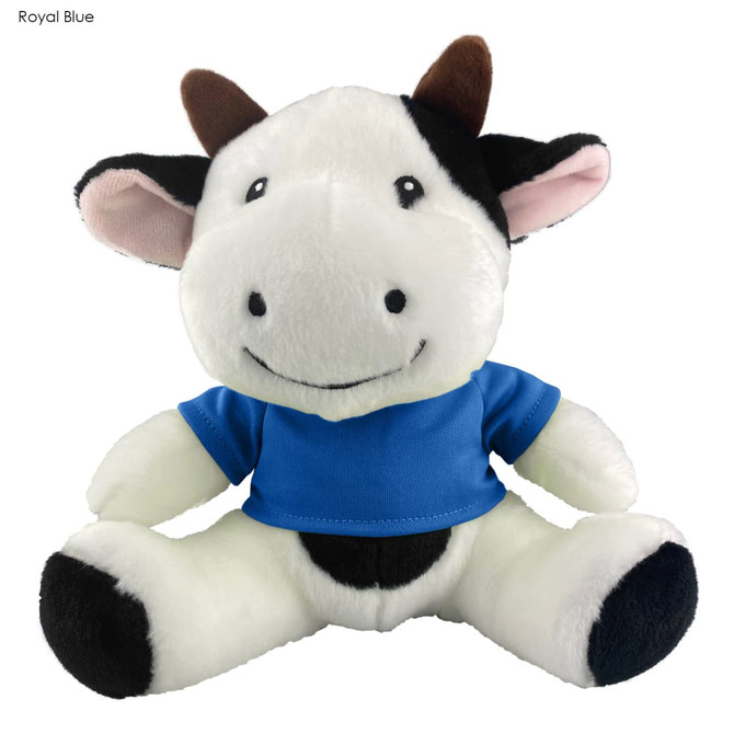 A plush cow toy with a smiling face, wearing a blue shirt, featuring black and white colouring, and brown horns.