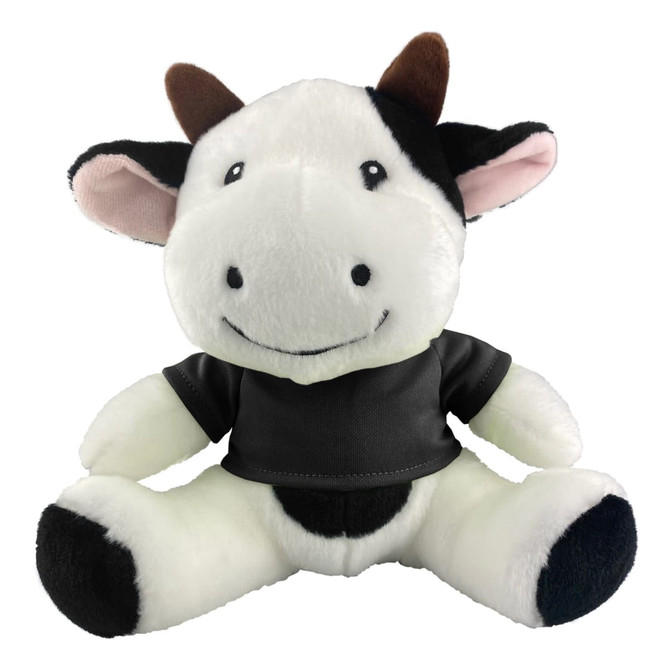 A plush cow toy in black and white with a smiling face and a black shirt, featuring a small logo.