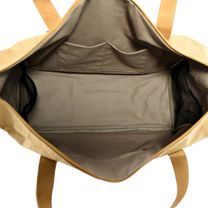 A large, tan Kraft paper travel bag with a spacious interior and multiple pockets. It features sturdy handles and a logo.