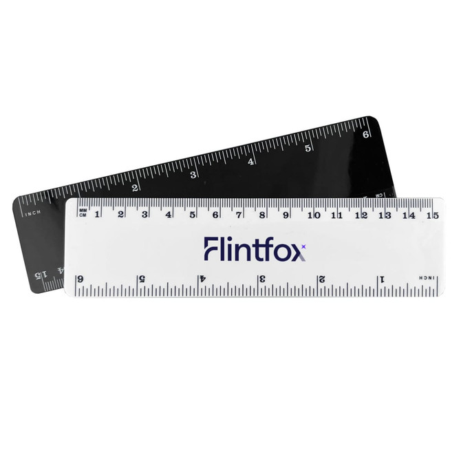 A 15cm plastic ruler in white and black, featuring measurement markings and a branding logo.