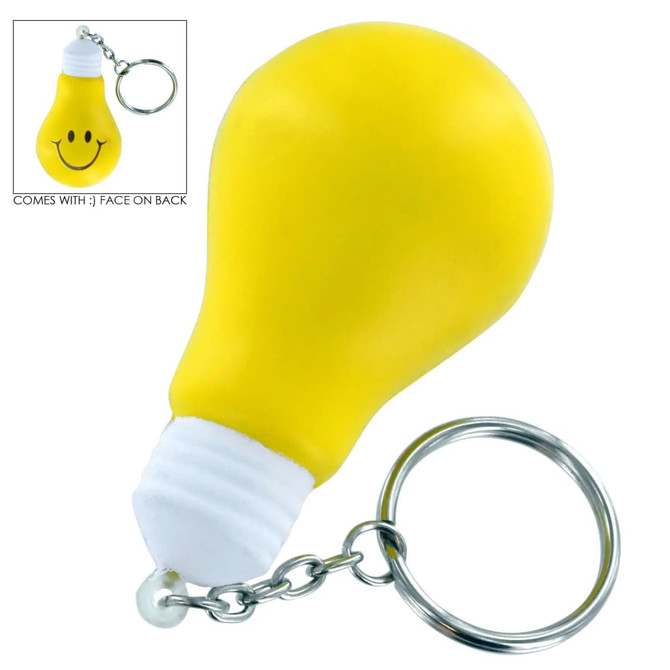 A yellow light bulb key ring with a smiley face on the back and a metal keychain.