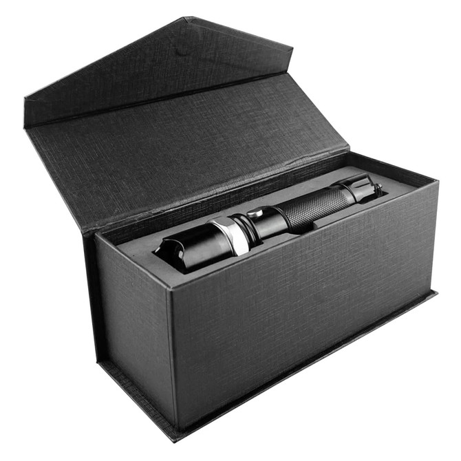 A black torch is displayed inside a sleek black gift box, featuring a textured finish and a secure closure.