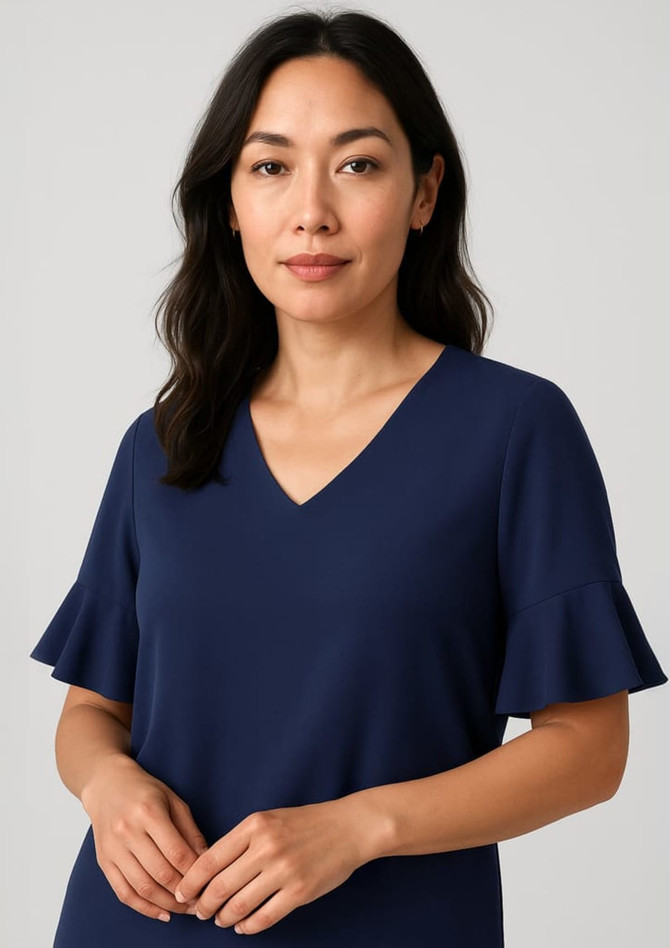 Navy blue blouse featuring fluted sleeves and a V-neckline, modelled by a woman with dark hair.