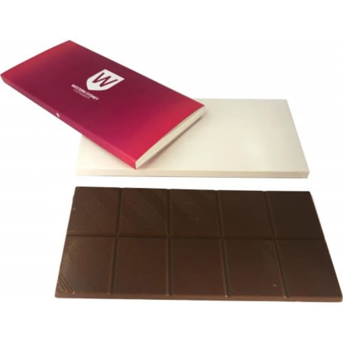 A chocolate bar in a wrapper with a white and pink design. The bar is dark brown, divided into segments.