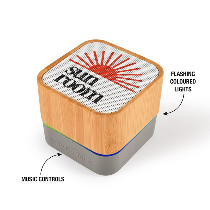 A bamboo Bluetooth speaker with flashing coloured lights and music control buttons, featuring a logo on the top.