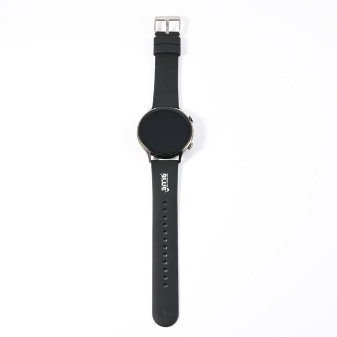 A black smart watch with a round face and a silicone strap, featuring a logo on the band.