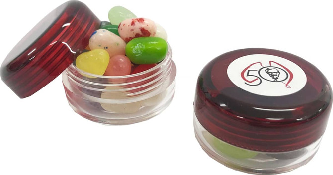 A clear screw cap jar in red with assorted JELLY BELLY jelly beans inside, featuring one logo on the lid.