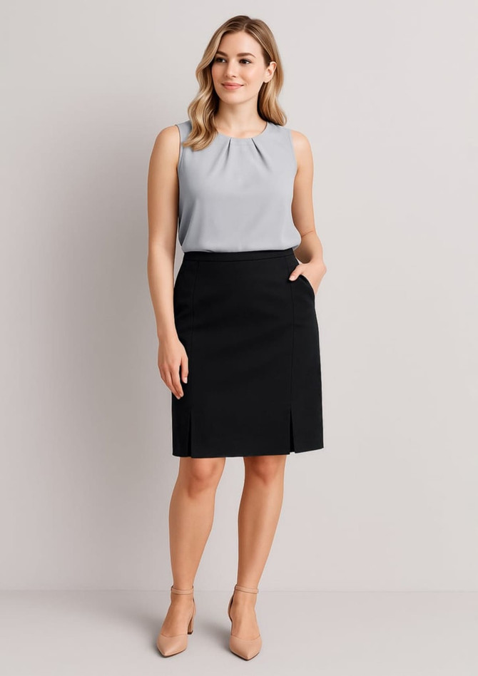 A model wearing a grey top and a black straight skirt with front pleat detail, featuring side pockets.