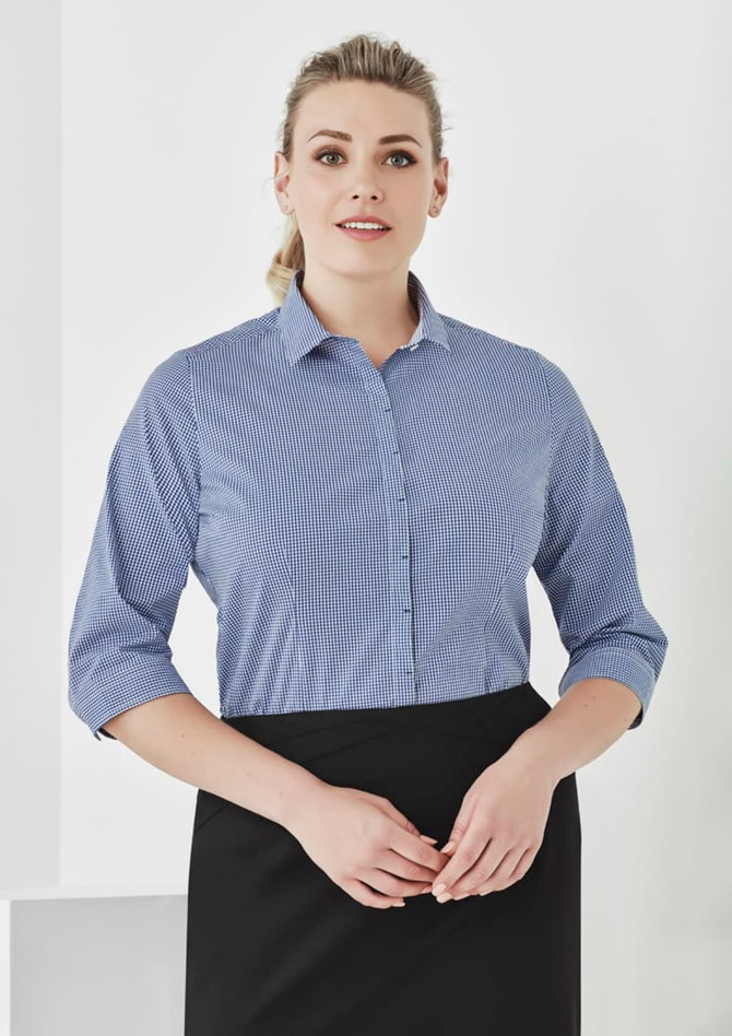 A blue and white checked 3/4 sleeve button-up shirt with a collar, featuring a logo on the fabric.