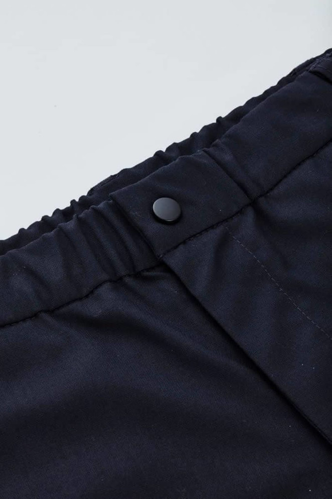 A close-up of black men's comfort waist cargo shorts featuring a button closure and elastic waistband.