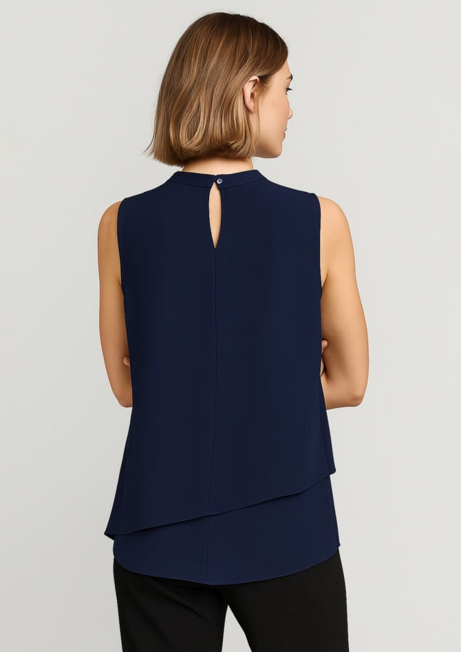 A navy sleeveless blouse with a layered design and a keyhole back detail, featuring a logo.