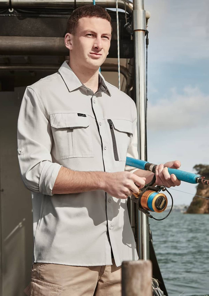 A light grey long sleeve button-up shirt with two chest pockets, worn by a man holding a fishing rod by the water.