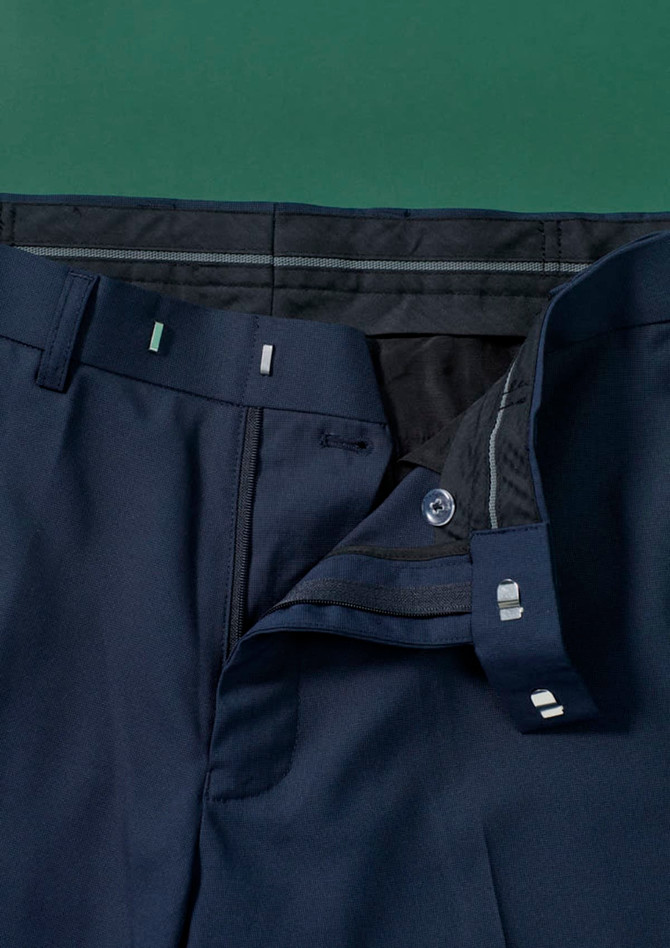 A pair of navy blue straight leg pants featuring an adjustable waist and a side button closure. The fabric is smooth and tailored.