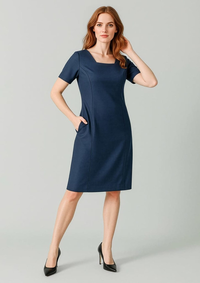 A navy short sleeve dress with a square neckline and pockets, featuring a fitted silhouette. It has a logo.
