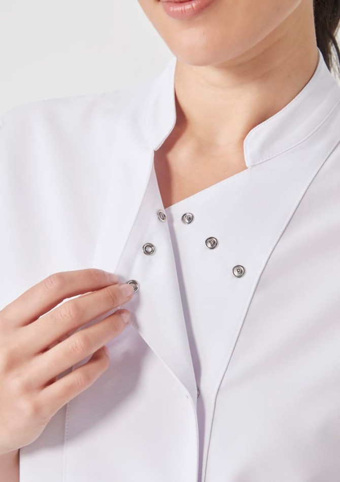 A white women's jacket featuring a snap button closure. The fabric appears smooth and contemporary.