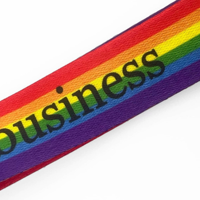 A colourful lanyard featuring a bold rainbow design with the word "business" in black.