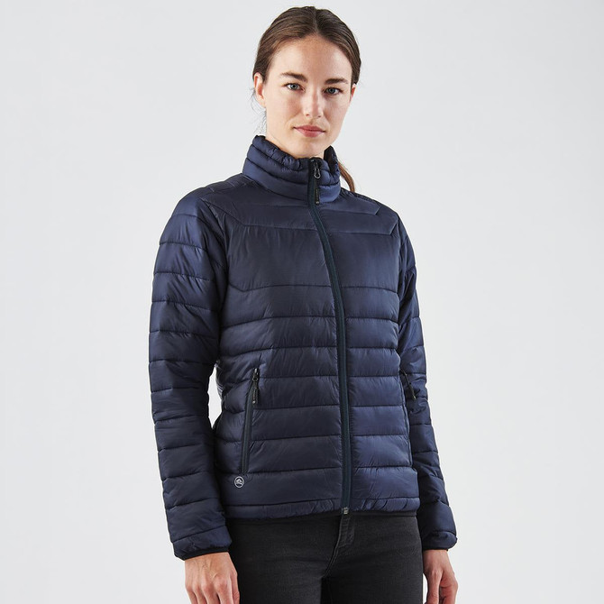 A navy women's padded jacket featuring a high collar and zip pockets, with a logo on the sleeve.