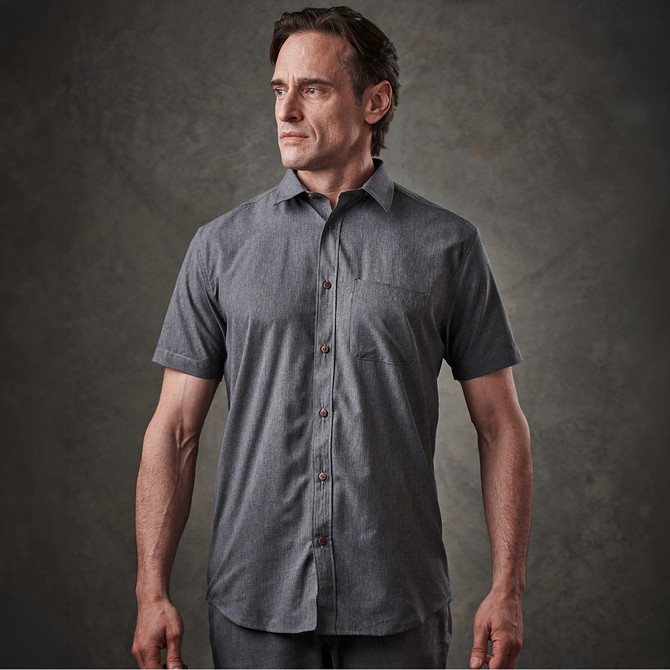 A button-up shirt in dark grey with short sleeves and a front pocket, featuring a logo.